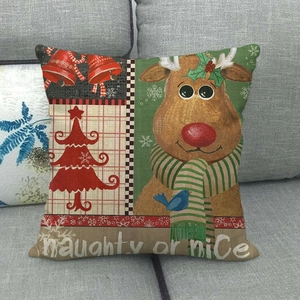 Close-up of linen Christmas pillowcase with reindeer, bells and naughty or nice text