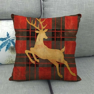 Christmas buffalo plaid linen pillow cover featuring a yellow reindeer silhouette on a sofa