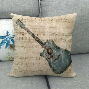 Detail of acoustic guitar and music notes print on retro beige decorative pillow