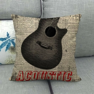 Detail view of vintage acoustic guitar cushion cover on a gray sofa with linen texture