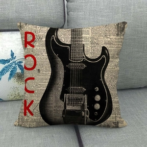 Detail of rock style cushion cover with electric guitar print and newspaper background