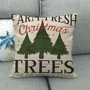 Close-up of farmhouse style Christmas tree print on beige linen texture cushion cover