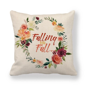 Macro detail of Falling FOR Fall lettering and floral wreath on linen pillow case