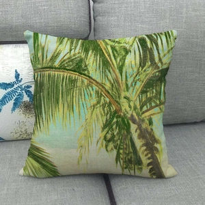 Detailed close-up of palm leaf print on textured linen fabric of the square pillowcase