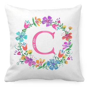 Peach skin pillowcase featuring floral wreath and letter C on white background