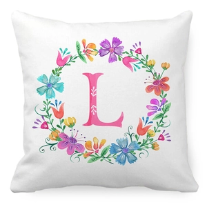 Detail view of peach skin fabric pillowcase featuring floral wreath and letter L design