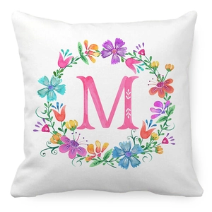 Macro detail of square peach skin pillowcase with floral wreath and letter M print