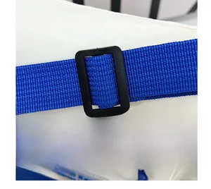 Detail of adjustable black plastic buckle and dark blue nylon strap on white messenger bag