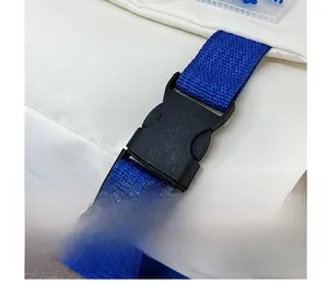 Close-up of black plastic buckle on white nylon messenger bag with blue woven strap
