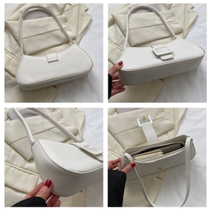 Detail view of white PU leather baguette bag showing interior capacity and magnetic closure