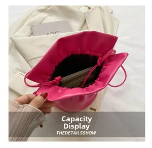Internal capacity of rose red bucket bag showing space for phone and wallet