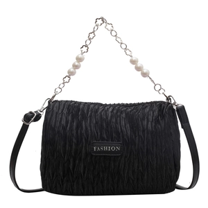 Minimalist black pleated crossbody bag with decorative pearl chain and flower accents