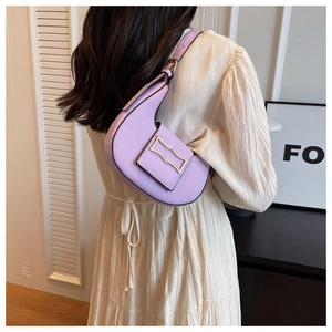 Detail of light purple leather crescent bag with golden buckle and adjustable shoulder strap
