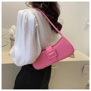 Detail shot of bright pink PU leather shoulder bag featuring a large decorative buckle