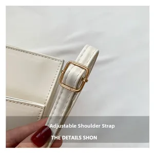 Detail of adjustable cream leather shoulder strap with a polished gold metal buckle