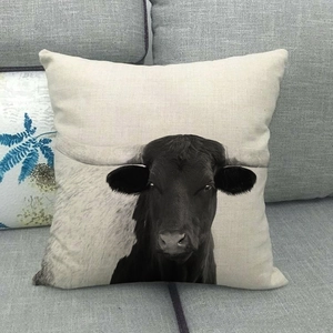 Macro detail of high-quality linen cushion cover featuring a realistic black bull print