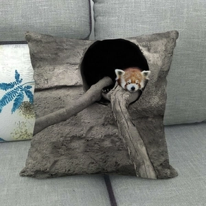 Detail of square cushion cover showing a sleeping red panda on a grey fabric sofa