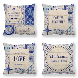 Detailed close-up of four linen pillow covers featuring blue geometric wreath tile patterns