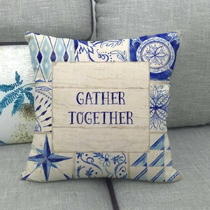 Linen pillowcase with blue geometric patterns and Gather Together typography on a sofa