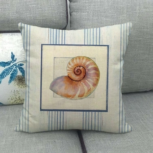 Detail of nautical cushion with nautilus shell print on striped cotton linen fabric