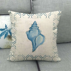 Detailed texture of cotton linen pillow cover with blue seashell print on grey sofa