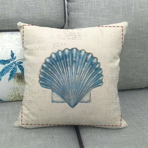 Detailed macro texture of light blue sea shell pillow cover on a modern gray sofa