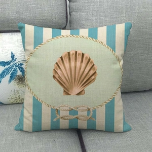 Detail of blue striped cushion cover featuring a beige seashell print on linen fabric