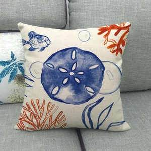 Nautical throw pillow cover featuring sea life patterns on linen fabric on a gray sofa