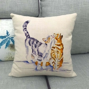 Close-up of watercolor cat illustration on a linen textured pillowcase on a sofa