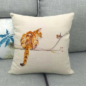 Close-up of cat and bird watercolor illustration on linen texture pillowcase on sofa