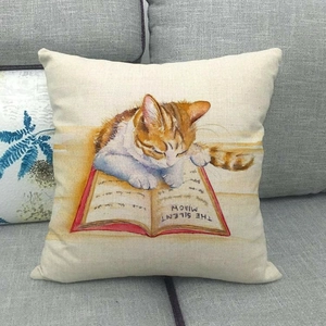 Detailed texture of linen cushion cover featuring a cat lying on a book on a sofa