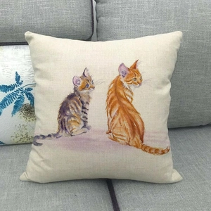 Texture detail of linen pillowcase featuring artistic painted cats on a grey sofa