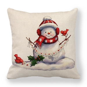 Detail of linen Christmas snowman pillow cover featuring cute red birds and winter berries