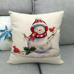 Christmas snowman cartoon cushion cover in linen fabric on a gray sofa for holiday decor