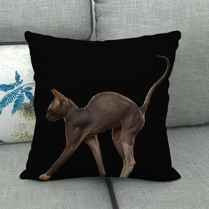 Detailed view of black linen pillowcase with Sphinx cat print on a gray fabric sofa