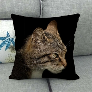 Black linen pillowcase featuring a realistic tabby cat portrait on a grey sofa