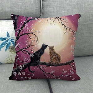 Linen cushion cover featuring cats under a full moon with cherry blossoms on a sofa