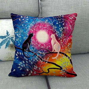 Artistic cat and full moon print on textured linen pillowcase placed on a grey sofa