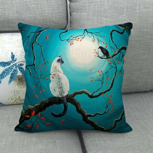 Artistic cat and crow illustration on a linen pillow case displayed on a sofa