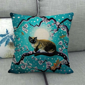 Close-up of linen pillowcase featuring a Siamese cat and cherry blossoms on a sofa