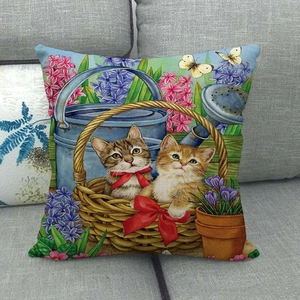 Linen throw pillow cover featuring two cute kittens in a garden basket on a sofa