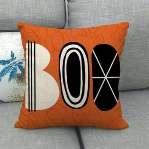 Detail of Halloween linen pillowcase with BOO text on orange pumpkin pattern background