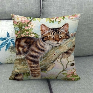 Detailed texture of linen cushion featuring a hand-painted tabby cat sleeping on cherry blossoms