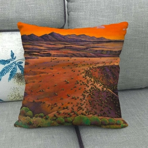 Detailed texture of linen pillow cover with cartoon landscape oil painting on a gray sofa