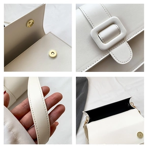 Detail view of white leather crossbody bag features magnetic closure and neat stitching