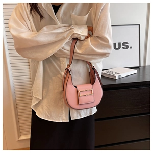 Detail of pink hobo bag featuring smooth synthetic leather and a gold metal buckle