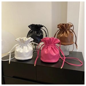 Collection of colorful drawstring bucket bags in white, black, brown, and pink finishes