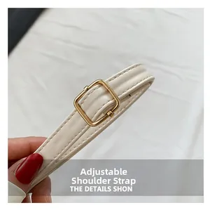 Detail show of adjustable off-white leather strap with gold square metal buckle on handbag
