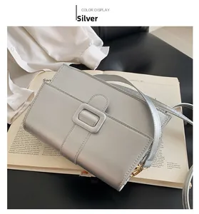 Silver vintage crossbody bag featuring a matte metallic finish and square buckle detail