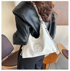 Gros plan du sac porté épaule blanc avec logo embossé et bandoulière chaîne argent